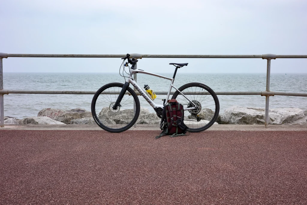 VTT Specialized posé contre une barrière en bord de mer.